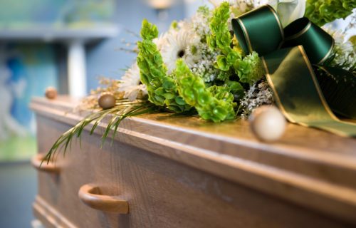 A coffin with a flower arrangement at a mortuary